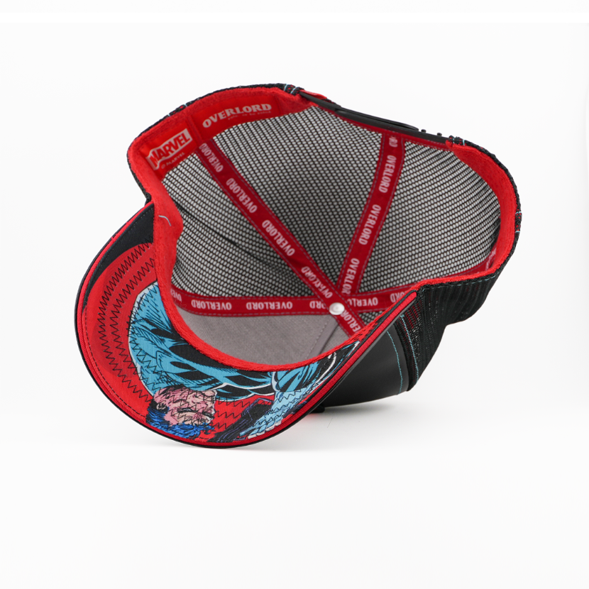 Underside view of the Punisher cap showing a comic-print brim, black mesh crown, and red Overlord branded taping.