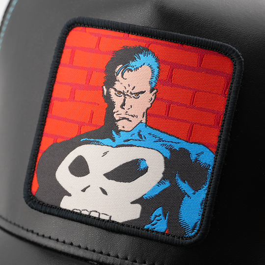 Close-up of a woven Marvel's Punisher patch featuring the iconic skull emblem on a brick backdrop.