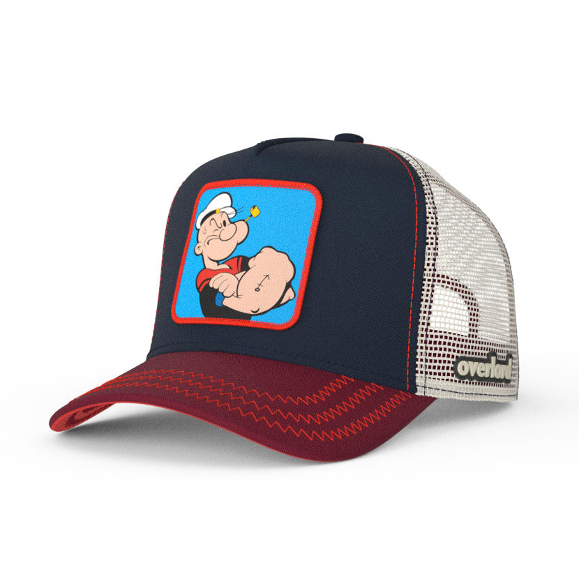 Navy and red OVERLORD X Popeye smug Popeye trucker baseball cap hat with red zig zag stitching. PVC Overlord logo.