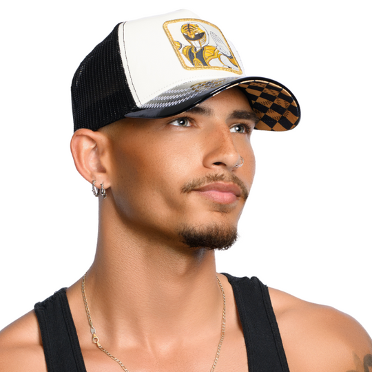 Man wearing shiny black and white faux leather trucker cap featuring a Power Rangers White Ranger woven patch on crown.