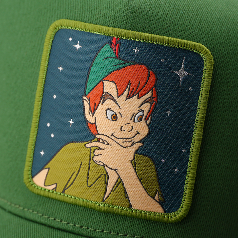 Woven patch of Peter Pan from Disney's Peter Pan smiling against a starry night background, with a green border, stitched onto the green retro trucker cap.