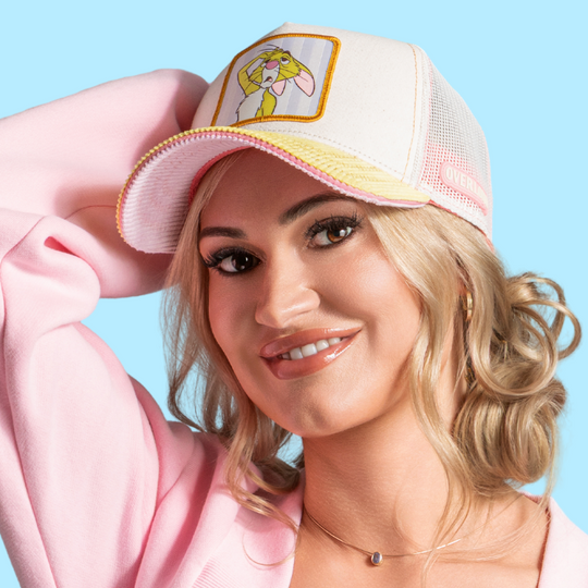 Model wearing the off-white Rabbit trucker cap with pink and yellow brim and off-white mesh sides.