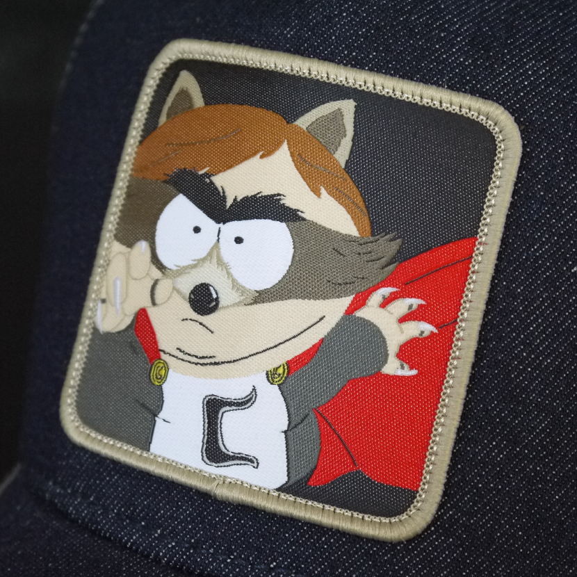 Dark blue denim OVERLORD X South Park Cartman Coon trucker baseball cap hat woven Overlord patch closeup.