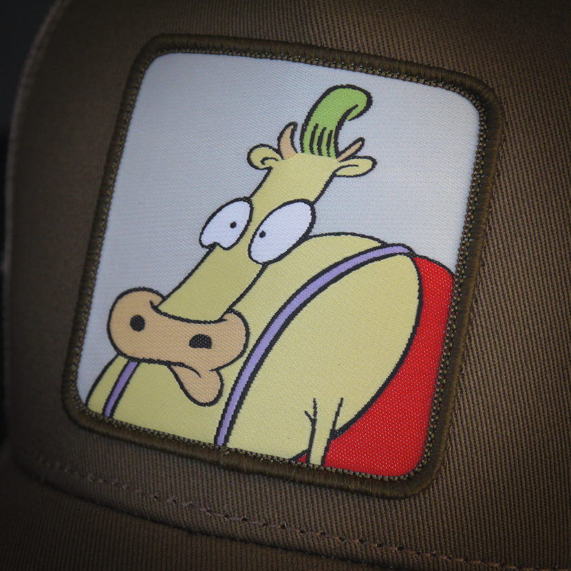 Dark tan OVERLORD X Rocko's Modern Life Heffer Wolfe trucker baseball cap hat woven Overlord patch closeup.