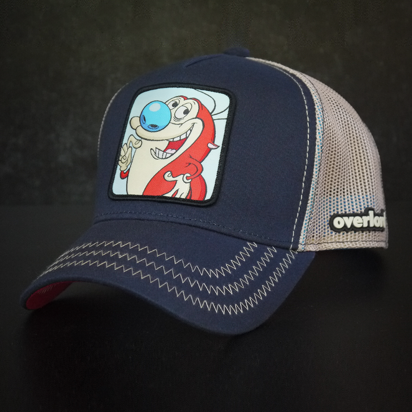 Navy OVERLORD X Ren and Stimpy smiling Stimpy trucker baseball cap hat with khaki zig zag stitching. PVC Overlord logo.