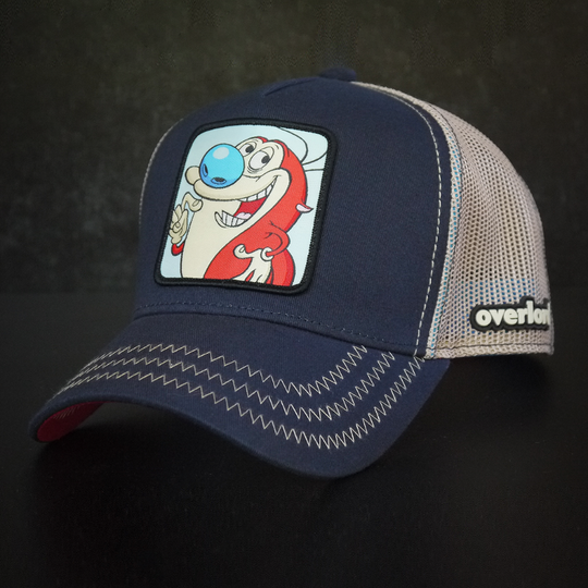 Navy OVERLORD X Ren and Stimpy smiling Stimpy trucker baseball cap hat with khaki zig zag stitching. PVC Overlord logo.