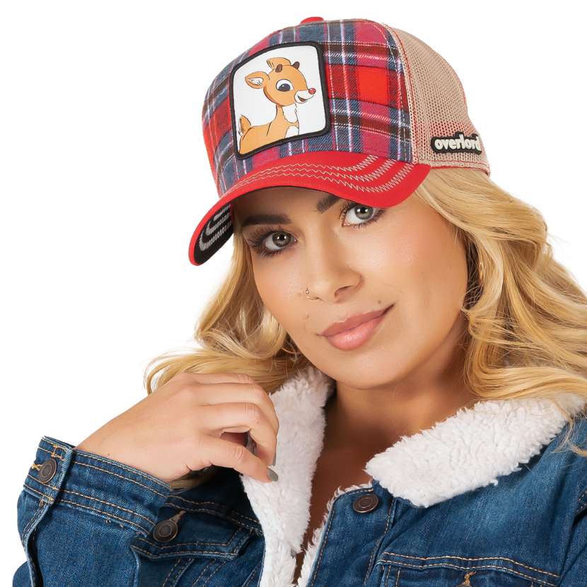 Woman wearing red and blue plaid trucker cap with khaki mesh featuring a woven patch of Rudolph the Red Nose Reindeer on the crown.