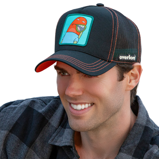 Man wearing black OVERLORD X SpongeBob Load of Barnacles fish trucker baseball cap hat with red orange stitching. PVC Overlord logo.
