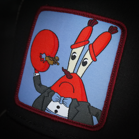 Black OVERLORD X SpongeBob Krabs playing tiny violin trucker baseball cap hat woven Overlord patch closeup.