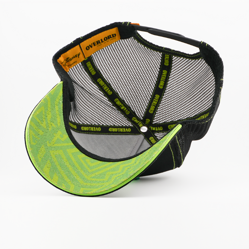 Underside of the Scar from Disney's The Lion King retro trucker cap showing a green patterned brim, black mesh crown, Disney tag, and black Overlord branded taping with green text.