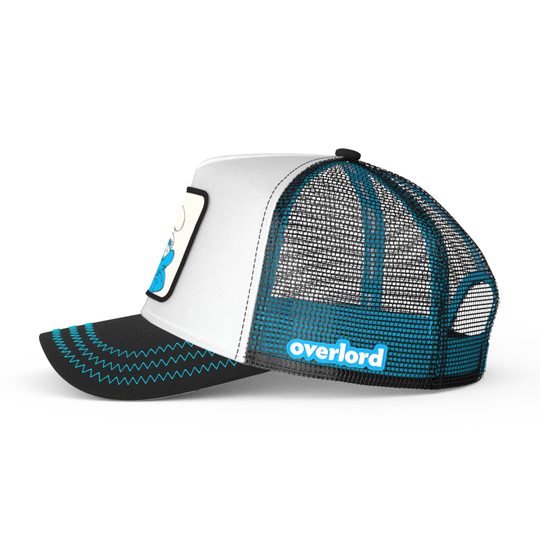 Black and white twill trucker cap with black mesh featuring a woven patch of Brainy Smurf from the Smurfs attached to crown