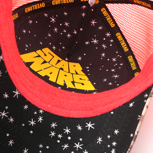 Close-up of the Sy Snootles trucker cap's underside showing a starry black lining with a yellow Star Wars logo and Overlord taping.