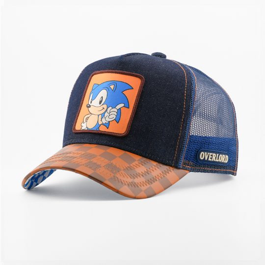 Denim-textured navy retro trucker cap with a brown-bordered patch of Sonic the Hedgehog on an orange background, brown checkered-pattern brim, navy mesh back, and Overlord logo.
