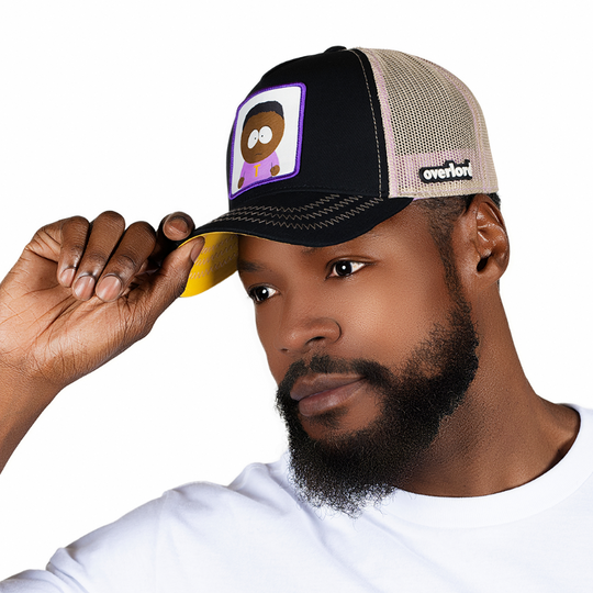 Man wearing black trucker cap with a woven patch featuring Tolkien from South Park on the front.