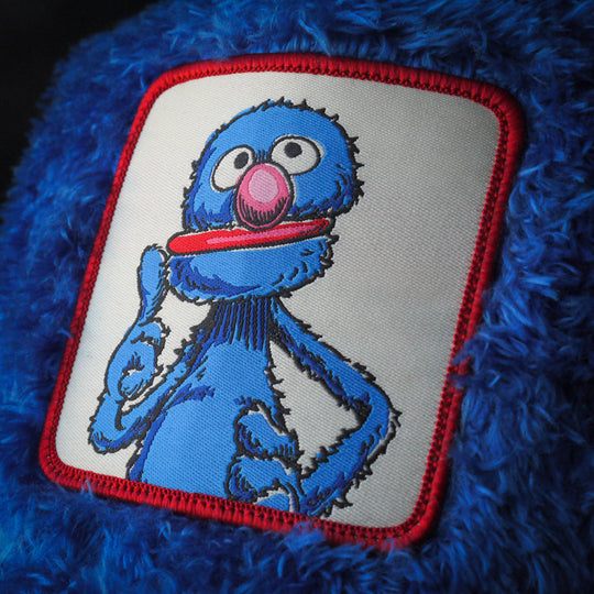 Close-up of Grover from Sesame Street on woven patch attached to trucker cap crown