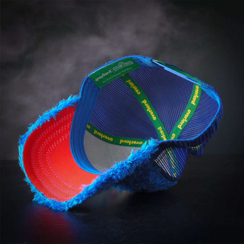 Inside view of blue faux fur trucker cap hat with red underbrim