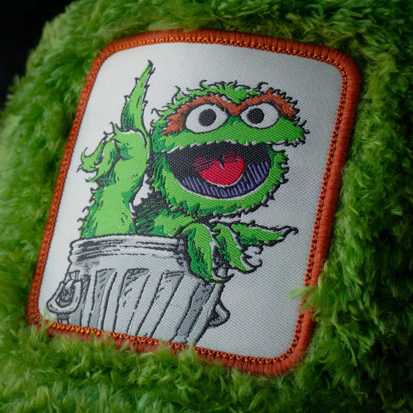 Close-up of Oscar the Grouch from Sesame Street on woven patch attached to trucker cap crown
