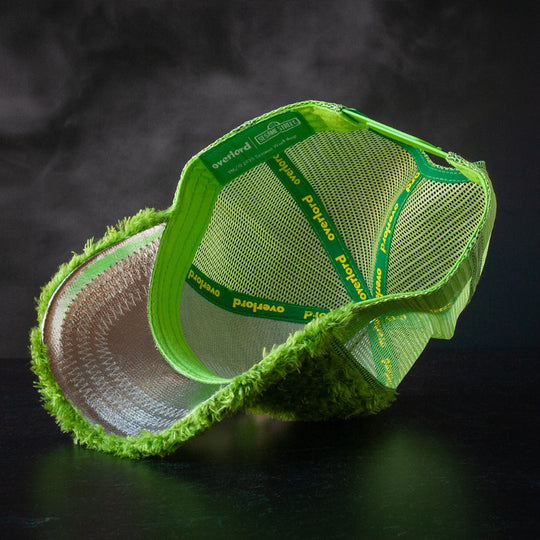 Inside view of green faux fur trucker cap hat with metallic silver underbrim