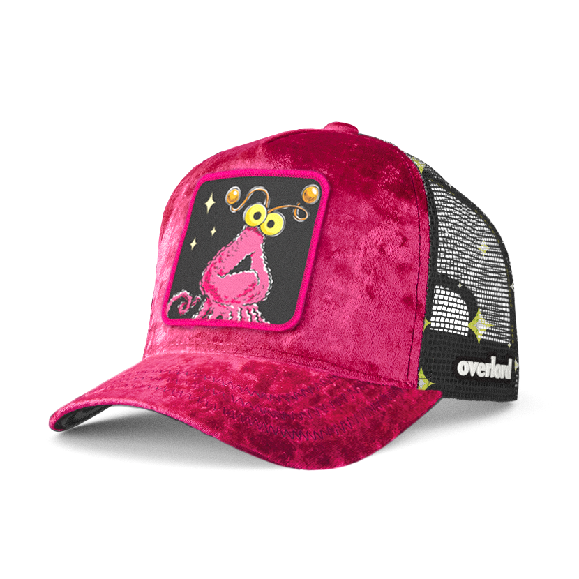 Hot pink crushed velvet trucker cap hat with Sesame Street pink yip martian woven patch against white background