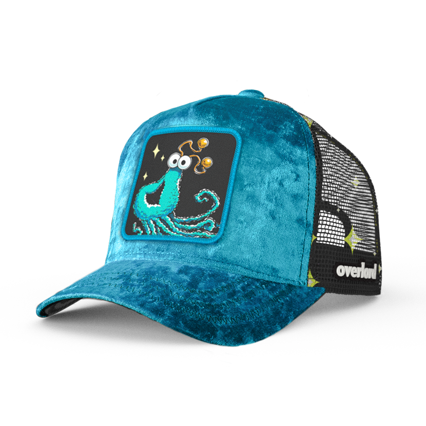 Blue crushed velvet trucker cap hat with Sesame Street blue yip martian woven patch against white background