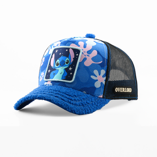 A blue and black trucker hat featuring a patch of the cartoon character Stitch on the front, with a blue knit brim and black mesh back panels. The side of the cap shows the brand name 'OVERLORD'.