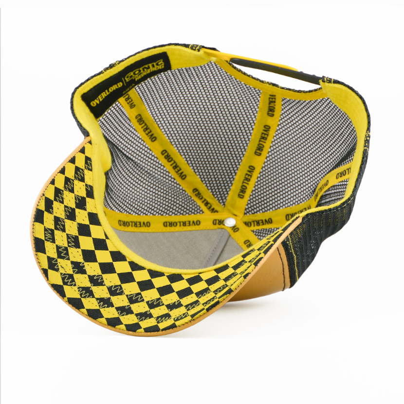 Underside of the Super Sonic from Sonic the Hedgehog retro trucker cap, showing a black and yellow checkered brim, Sonic the Hedgehog tag, grey mesh crown, and yellow Overlord branded taping with black text.