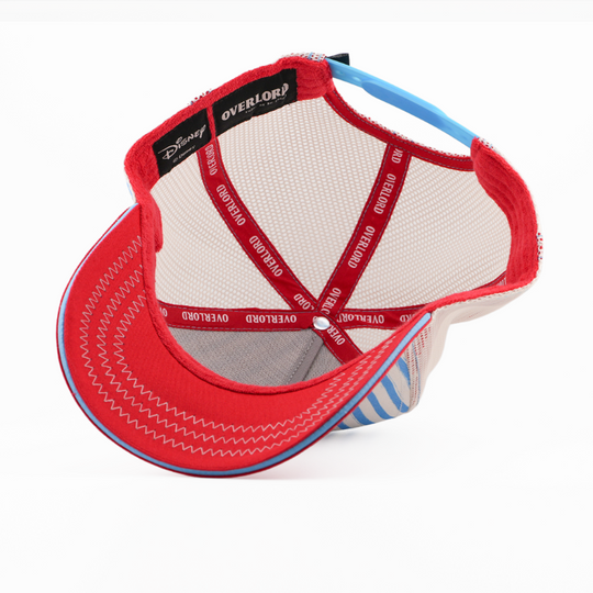 Underside of the Swedish Chef from The Muppets retro trucker cap, showing a solid red brim, a Disney tag, white mesh crown, and red Overlord branded taping with white text.