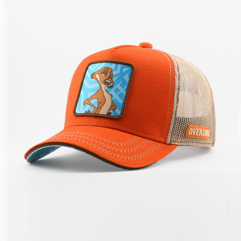 Orange corduroy-textured retro trucker cap with a woven Timon from Disney's The Lion King patch on a blue patterned background with a brown border, tan mesh back with Overlord logo.
