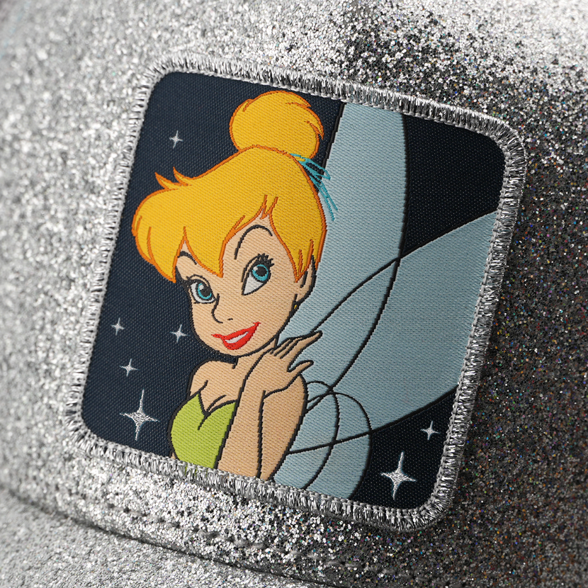 Woven patch of Tinker Bell from Disney's Peter Pan smiling with her wing visible against a starry night background, with a silver border, stitched onto the silver glitter-textured retro trucker cap.