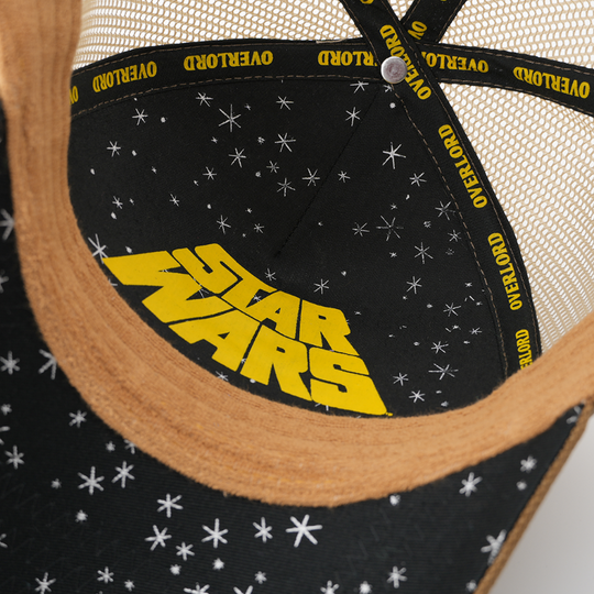 Close-up of the Tusken Raider cap's underside showing a starry black lining with a yellow Star Wars logo and Overlord taping.