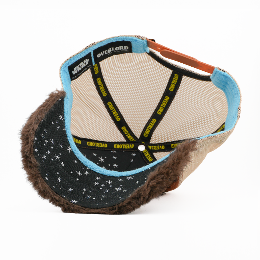 Underside view of the Wicket cap showing a starry fuzzy brim, tan mesh crown, and Overlord branded taping.