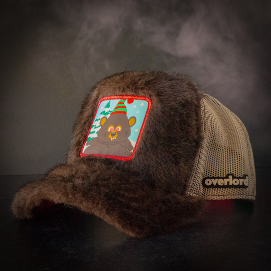 Faux bear fur trucker cap with khaki mesh featuring a woven patch of Woodland Critter Bear from South Park attached to the crown.