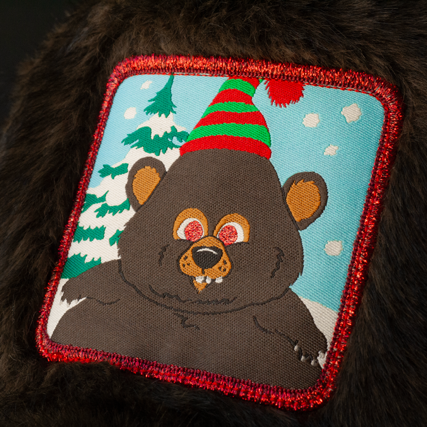 Close up of a woven patch of Woodland Critter Bear from South Park attached to the crown.