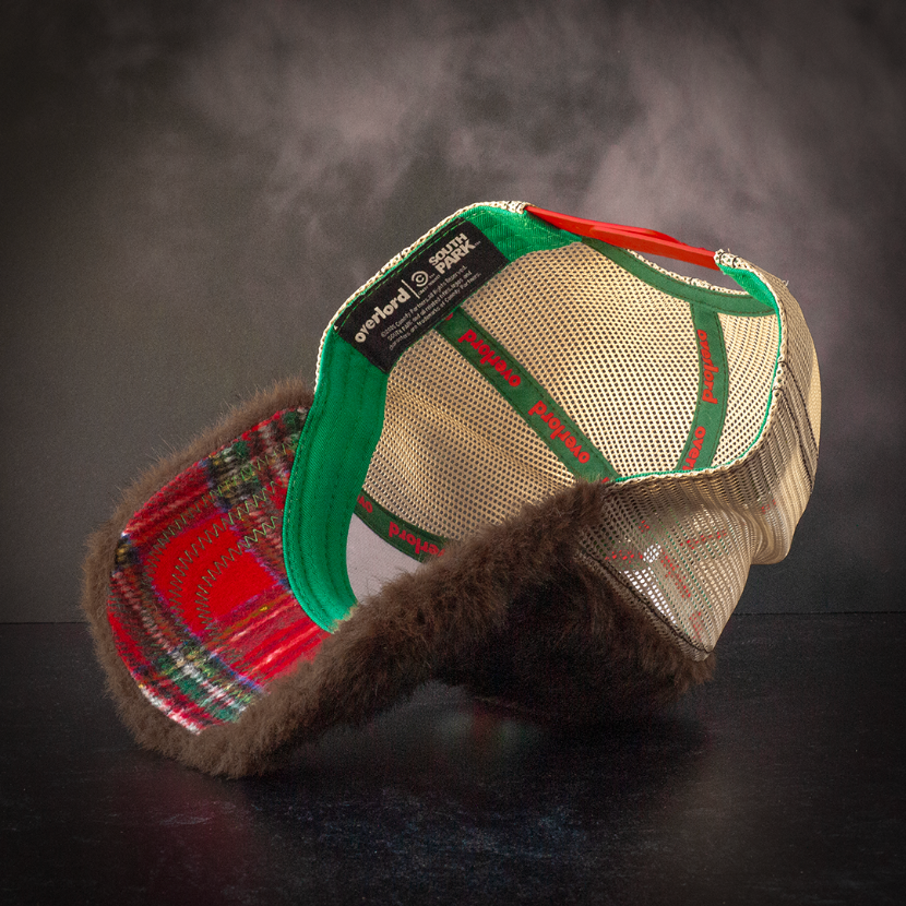Inside view of faux bear fur trucker cap with red christmas colored plaid on the underbrim.