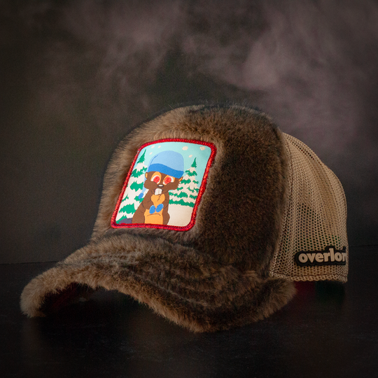 Faux beaver fur trucker cap with khaki mesh featuring a woven patch of Woodland Critter Beaver from South Park attached to the crown.