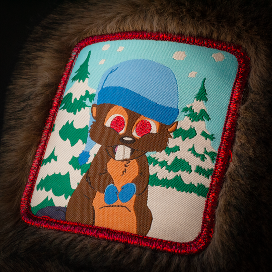 Close up of a woven patch of Woodland Critter Beaver from South Park attached to the crown.