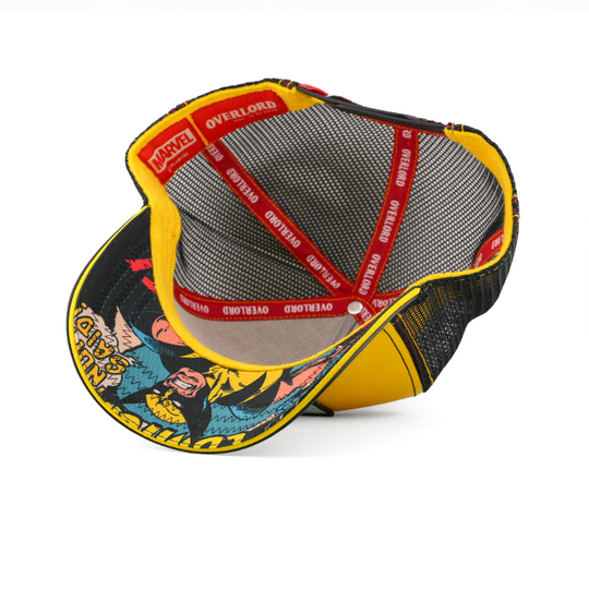Underside view of the Wolverine cap showing a comic-print brim, black mesh crown, and red Overlord branded taping.
