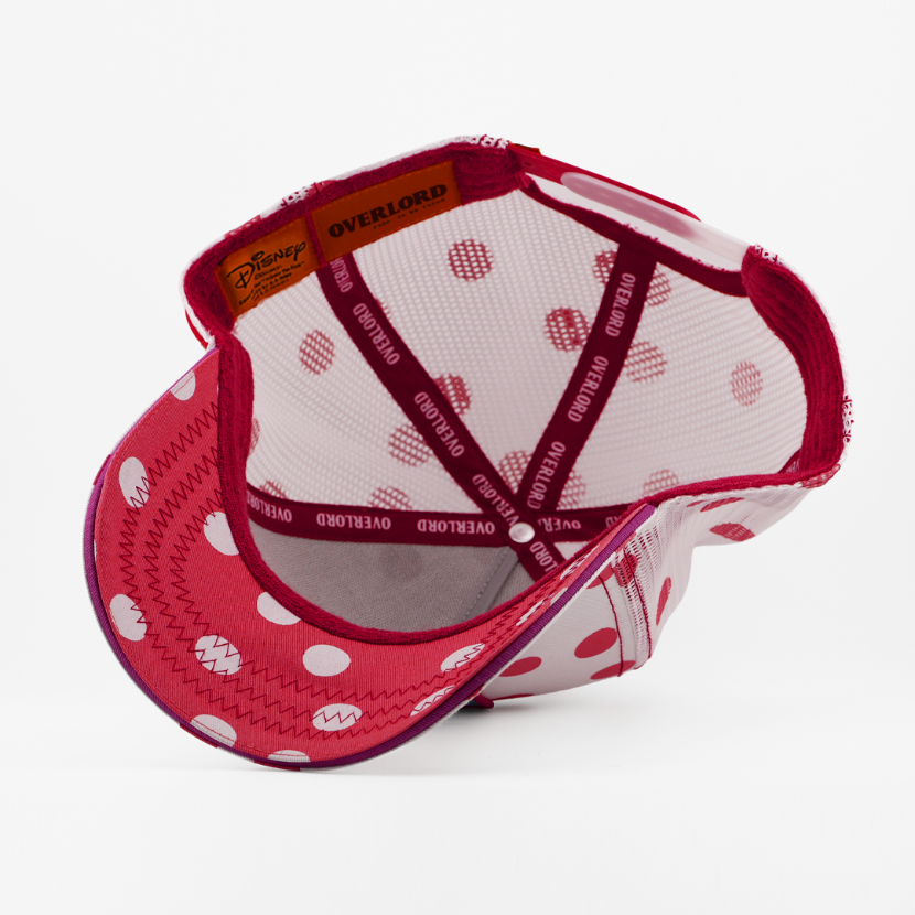 Red and white polka dot cap with mesh back on a white background